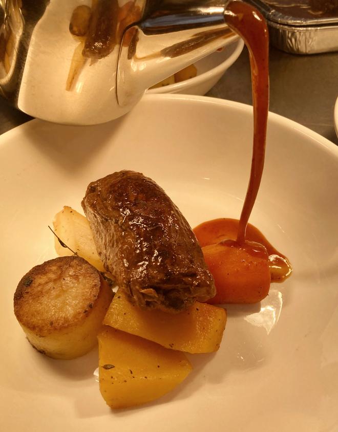 Prune and Apple Stuffed Pork Olive, Roasted Root Vegetables and Fondant potato with Calvados Jus